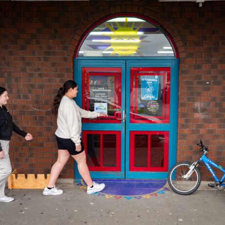 Roslyn Library front door with two young people about to enter