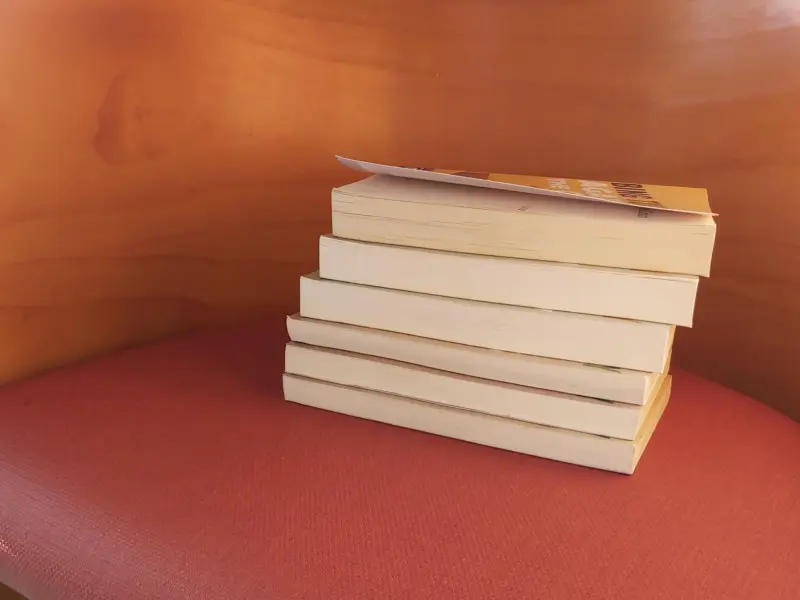 a pile of books on a chair