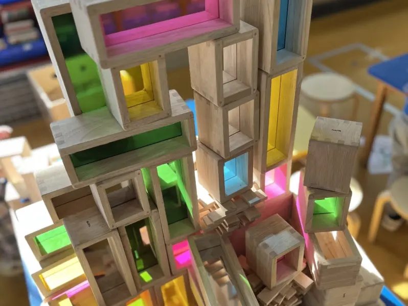A stack of wooden blocks with coloured plastic components