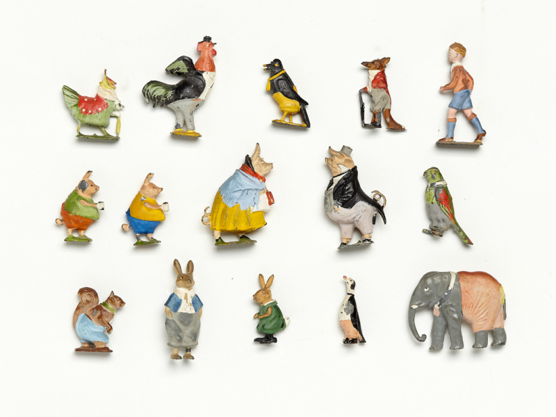 A collection of antique figurines, most of them anthropomorphic animals wearing clothes.