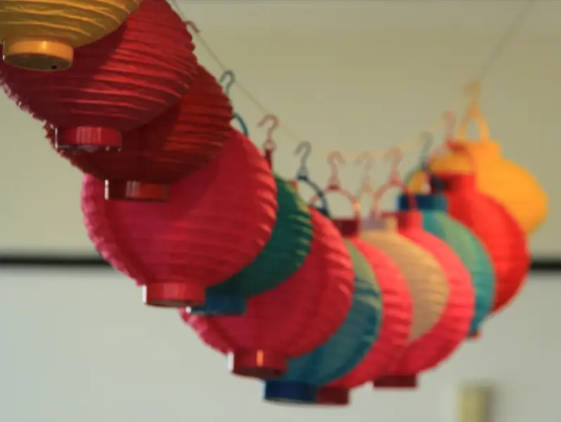 Multi-coloured Chinese style lanterns hanging from a string